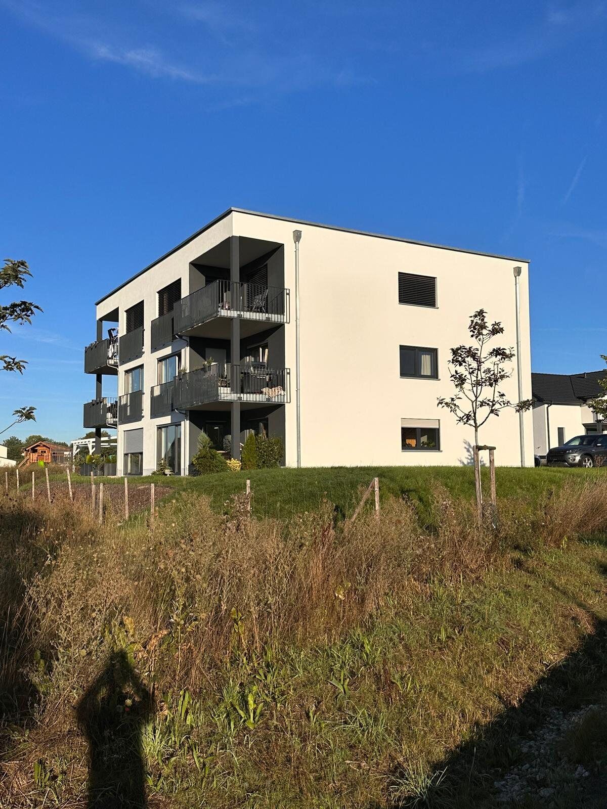 Seitliche Außenansicht des Mehrfamilienhauses am Hammerberg mit Balkonen